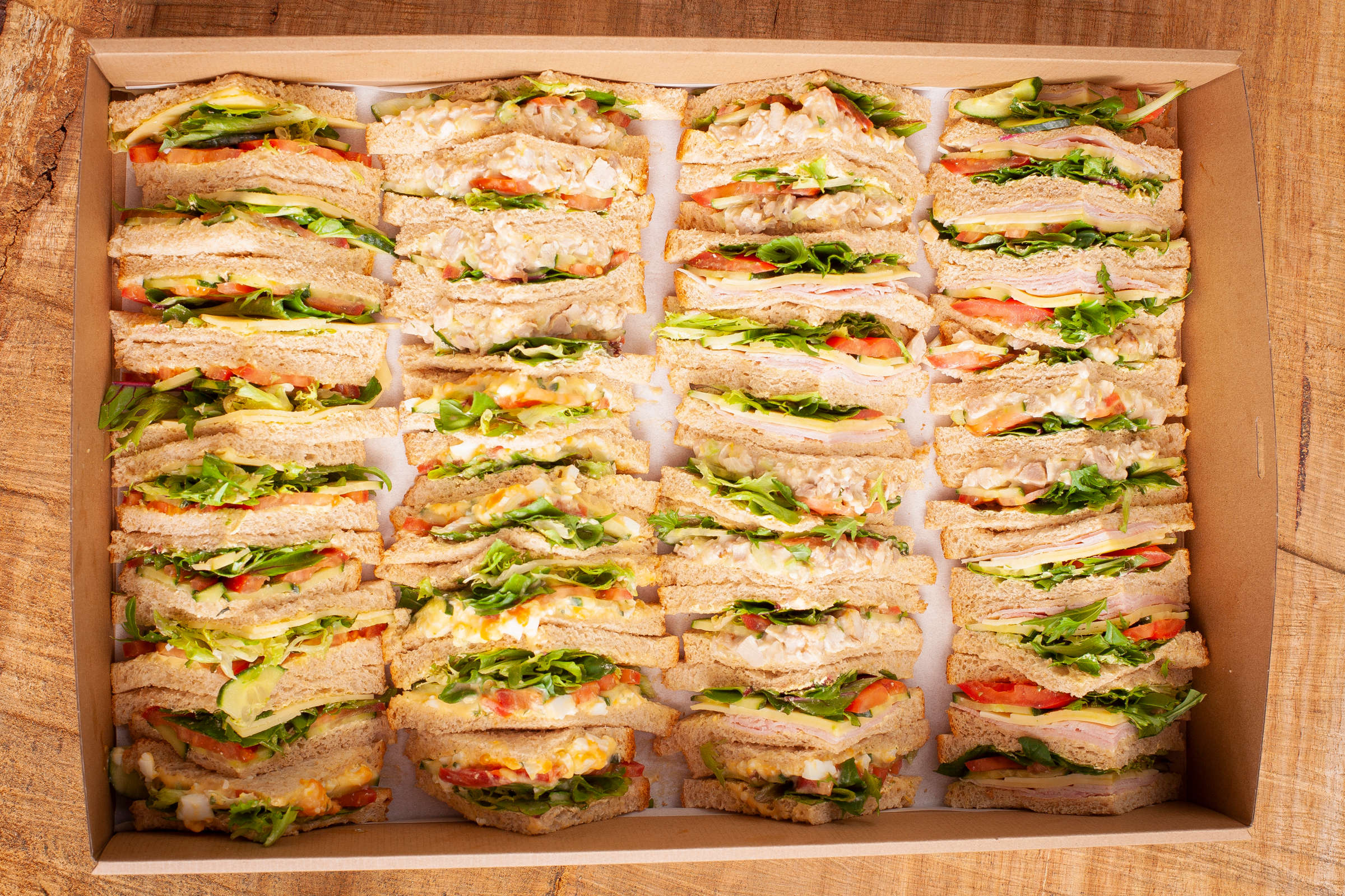 Mixed sandwich catering box containing 40 triangles, fillings include free range ham, vegetarian, free range chicken, egg and cheese all with assorted salad Credit: Richard Jupe.