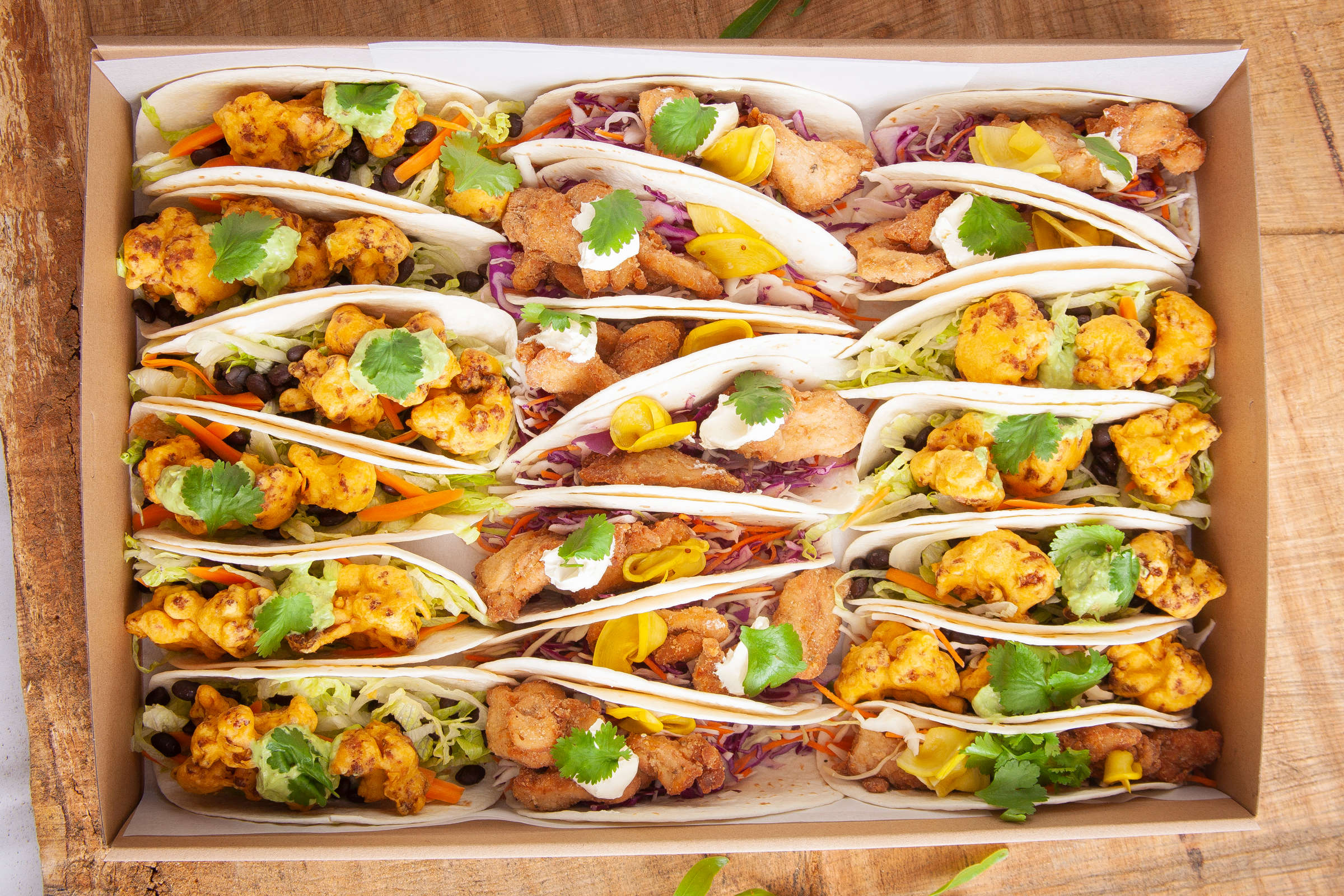 Large Taco box containing 20 tacos fillings include fried chicken and fried cauliflower. Credit: Richard Jupe.