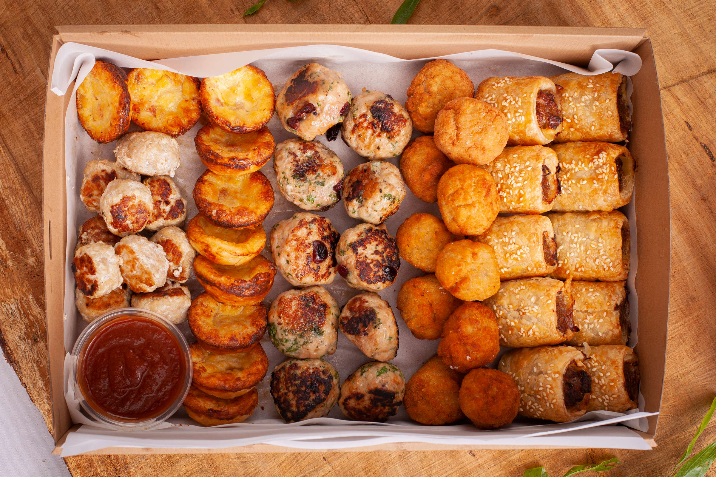 Hot Savoury box containing 50 items: Sausage rolls, Chicken balls, Smoked salmon arancini, Bacon and cheese tartlets, Meatballs. Credit: Richard Jupe.