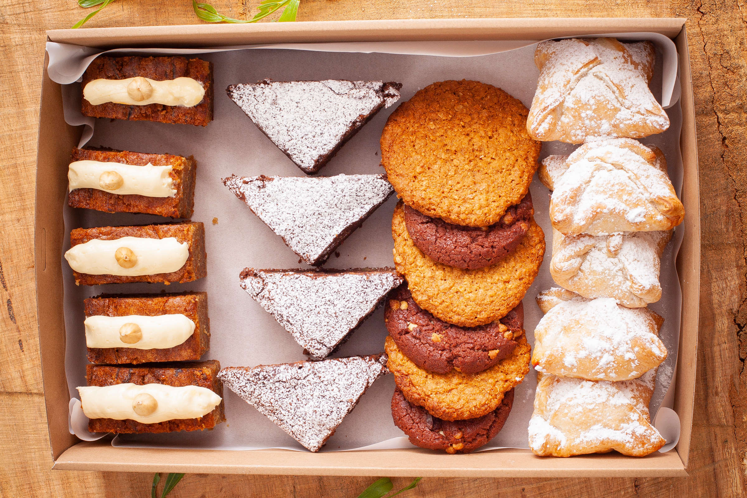 Large sweet selection box containing 20 items including chocolate brownie, Danish pastries, Carrot cake with cream cheese icing, Cookies. Credit: Richard Jupe.