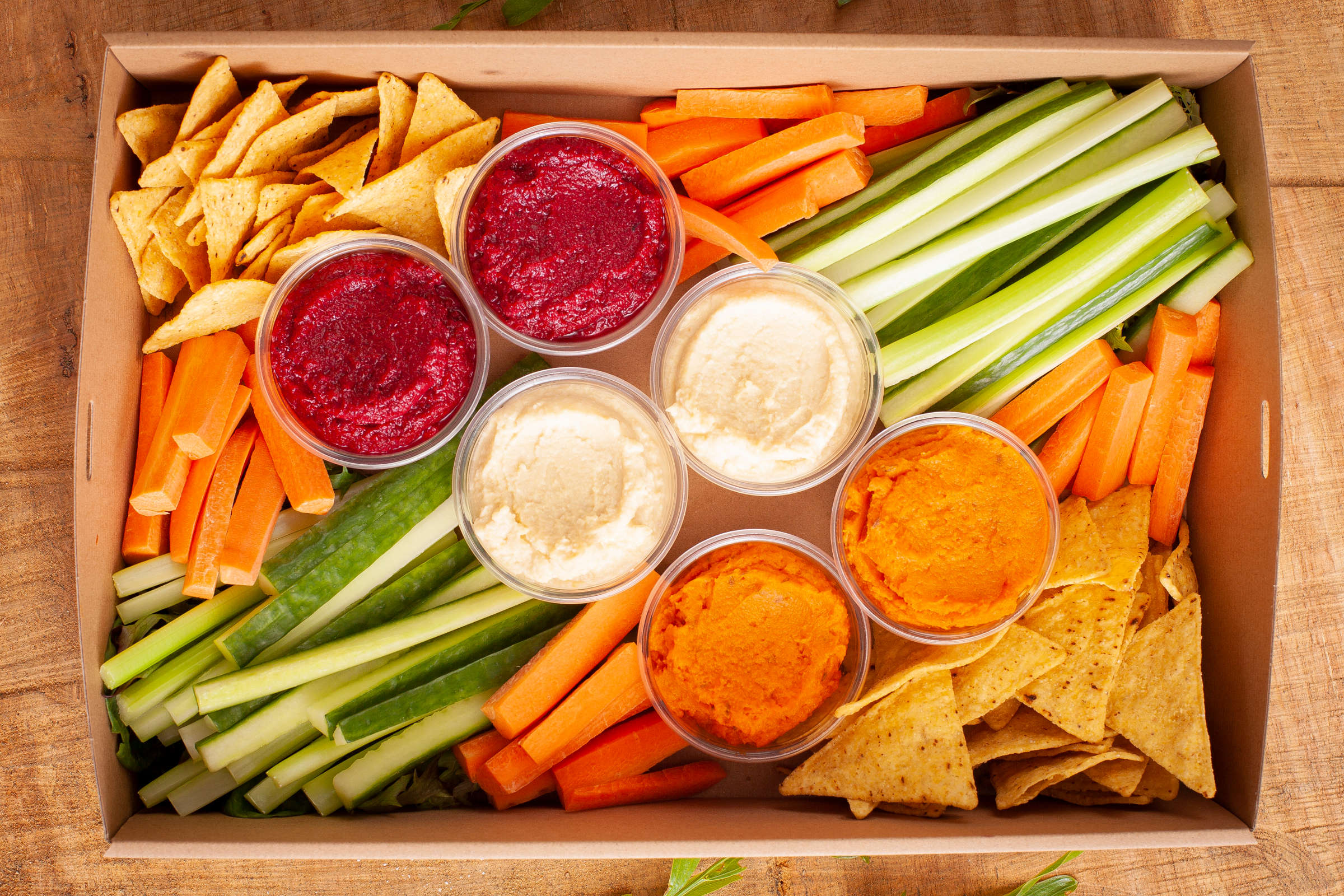 Dip and crudite catering box. Box pictured includes corn chips, carrot sticks, cucumber sticks, hummus, beetroot dip, and pumpkin and feta dips. Credit: Richard Jupe.