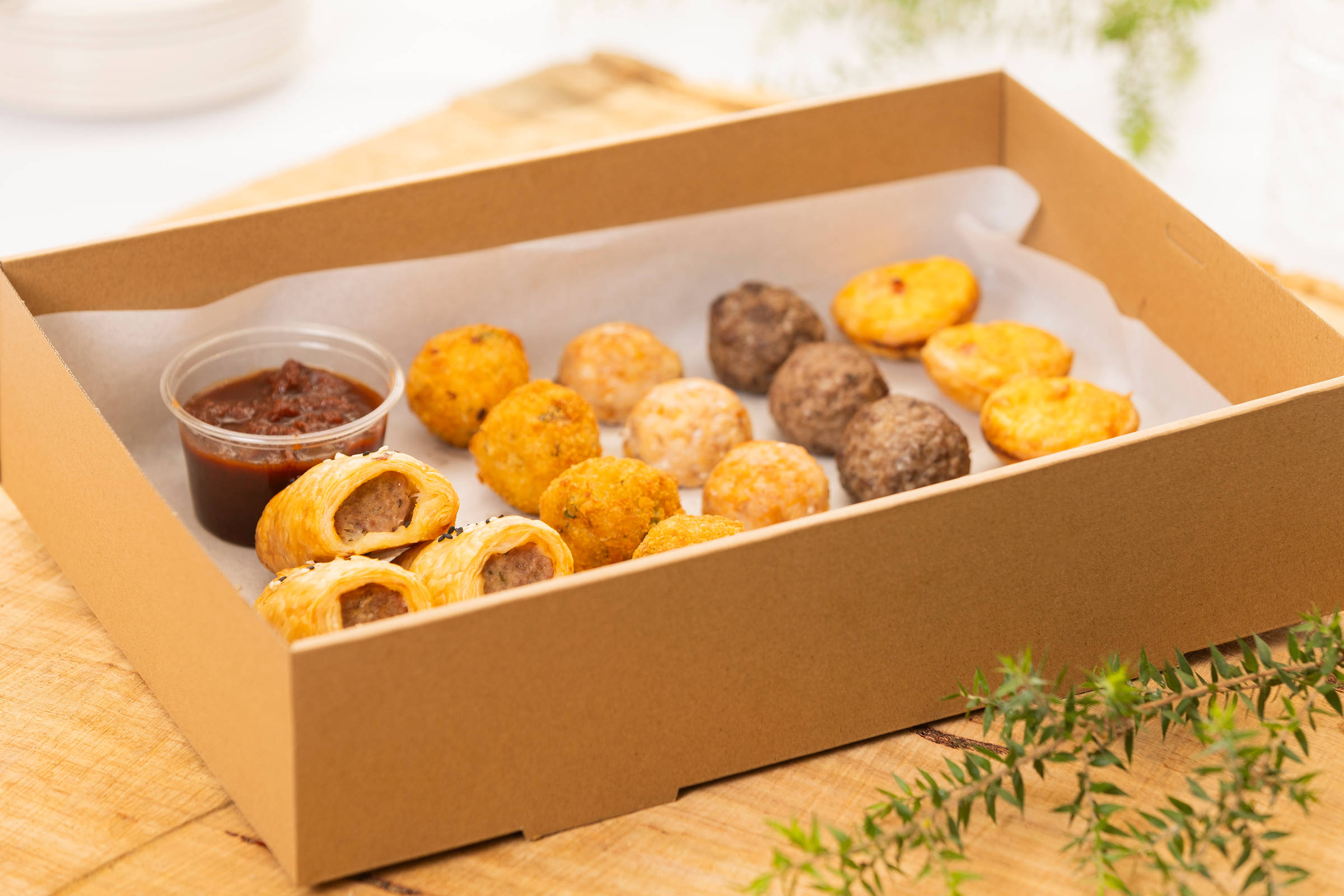 Hot Savoury box containing 25 items: Sausage rolls, Chicken balls, Smoked salmon arancini, Bacon and cheese tartlets, Meatballs. Credit: Richard Jupe.